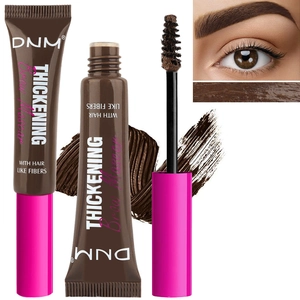 Detailed view of the fiber-enriched brow mascara tube, brush applicator and brown cream texture