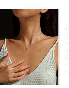 Elegant emerald-cut Moissanite pendant necklace on model's neckline for luxury look