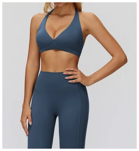 Detail of grey-blue halter V-neck sports bra and high-waisted yoga leggings set