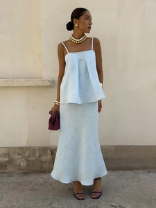 Detail of light blue linen set featuring a camisole top and fisheye maxi skirt