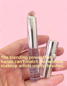 Detail of dual-ended silicone lip and concealer brush with silver metallic cap and handle