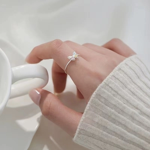 Elegant 925 silver open butterfly ring with colorful accents worn on a woman's finger