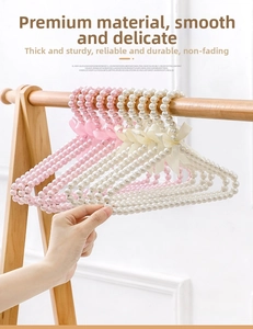 Close-up of elegant pearl pet hangers with decorative satin bows in white and pink