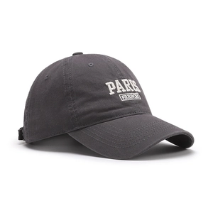 Charcoal grey washed cotton baseball cap with white Paris embroidery from a side view