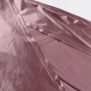 Detail showing high-quality satin fabric and side slit stitching on a mauve maxi dress