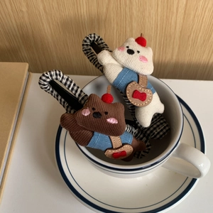 Cute plush bear hair clips in brown and white with blue overalls and checkered pattern