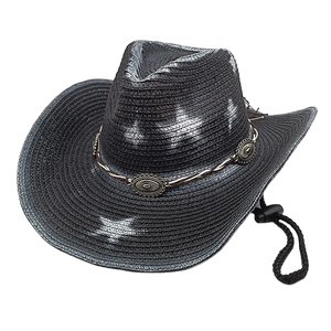 Detail of western straw hat with decorative brown band and vintage metal buckles