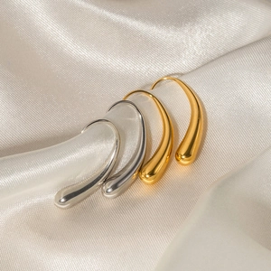 Minimalist 16K gold and silver stainless steel teardrop earrings on white silk fabric