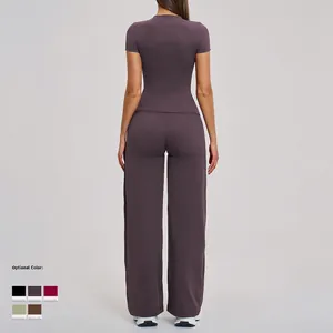 Dark purple high waist yoga set with tight short sleeve top and wide leg pants back view