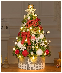 Detail of 60cm tabletop Christmas tree with warm lights, red bows and felt base