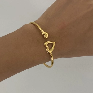 Gold stainless steel open heart bangle featuring hollow heart and solid bean design