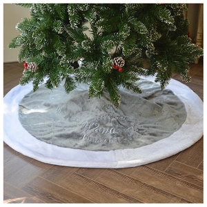Detail of grey plush Christmas tree skirt with white faux fur trim and embroidered text