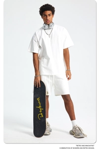 White oversized cotton T-shirt and drawstring shorts set in minimalist streetwear style