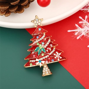 Enameled Christmas tree brooch with multicolored rhinestones on a festive background