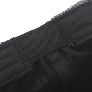 Detail of adjustable elastic band and precision stitching on black linen beret hat
