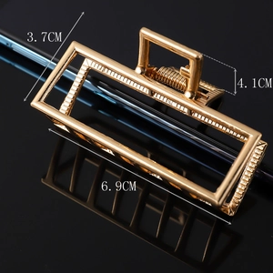 Detail showing dimensions of 6.9cm x 4.1cm gold metal geometric rectangular hair claw clip
