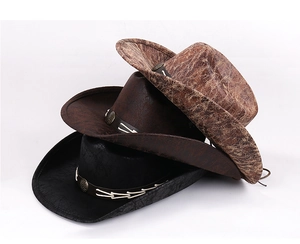 Close-up of stacked faux suede cowboy hats showing distressed textures and decorative metal bands