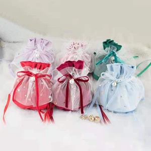 Detail of velvet mesh gift pouches with faux pearl decor and star patterns in six colors