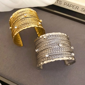 Bohemian multilayer twisted bangle with crystals in gold and silver finishes
