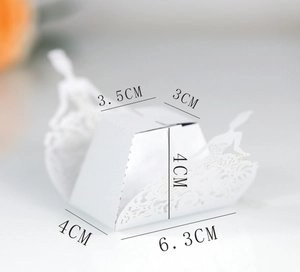 Macro detail of laser-cut white ballerina favor box with precise dimensions in centimeters