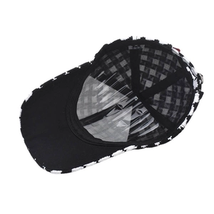 Close-up of the interior structure of houndstooth baseball cap with black sweatband and lining