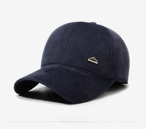 Side view of navy blue herringbone winter baseball cap with mountain logo metal emblem