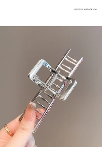 Detail of silver hollow square hair claw clip with inlaid pink rhinestones for women