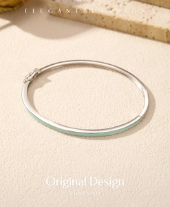Detail of s925 silver bangle featuring mint green enamel line and elegant hinge clasp