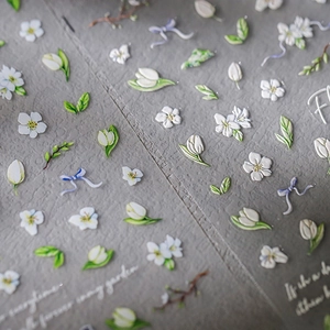 5D embossed nail stickers featuring white flowers, tulips and butterfly bows on transparent film