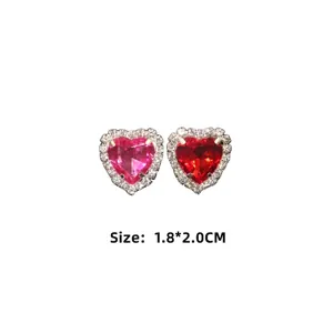 Asymmetric heart-shaped crystal earrings in pink and red with white rhinestone border