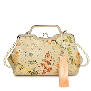 Oriental style floral embroidered shell bag with pearl handle and long tassel charm