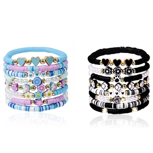 Handmade beaded bracelet set with hearts flowers and colorful charms on white background