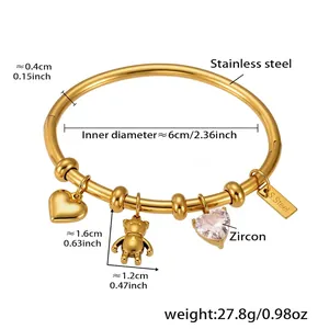 Detailed shot of 18k gold plated stainless steel bracelet with heart and bear charms