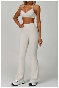 Detail of off-white backless yoga set featuring V-neck sports bra and flared leggings