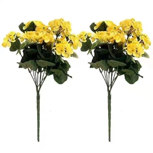 Detailed view of two lifelike yellow artificial geranium bouquets with green leaves