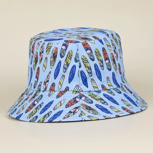Detail of light blue bucket hat with colorful surfboard prints and fine stitching