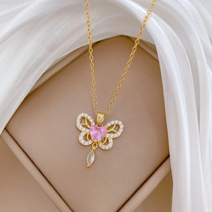 Detail of butterfly necklace with pink heart gem and zircons in a jewelry box
