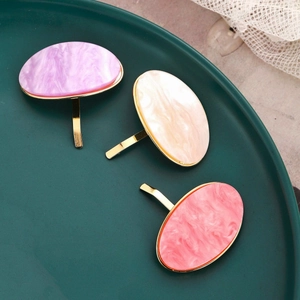 Three oval tortoise shell resin ponytail clips with gold alloy hooks in purple, pink, and white