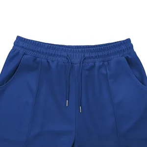 Detail of blue waffle knit shorts featuring elastic drawstring waist and metal aglets