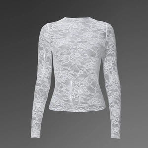 Close-up detail of white long-sleeved floral lace top featuring intricate hollow embroidery