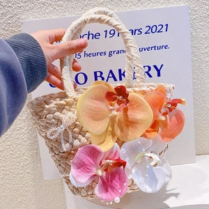 Bohemian beach straw tote bag with colorful orchid flowers and pearl bow accessory