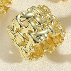 Macro shot of 14K gold plated braided texture ring with polished metallic finish