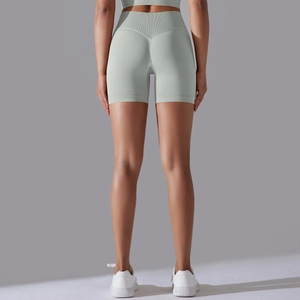 Detail view of mint green high-waisted seamless biker shorts with flattering scrunch butt seam