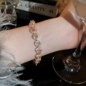 Luxurious pink heart crystal bracelet featuring sparkling stones in a gold setting
