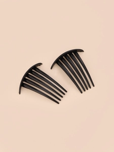 Close-up of a pair of black six-tooth plastic hair combs for women's styling accessories