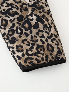 Detail view of leopard print quilted cotton jacket cuff with black edge binding