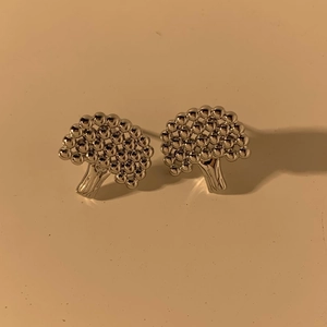 Silver broccoli shaped stud earrings in polished metal with textured tree design