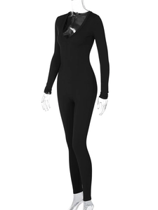 Detail view of the ribbed knit texture and slim fit design of a black long sleeve jumpsuit