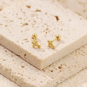 Macro view of gold s925 silver cross stud earrings with sparkling cubic zirconia stones