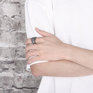 Close-up of vintage crown engraved titanium steel ring on male model finger